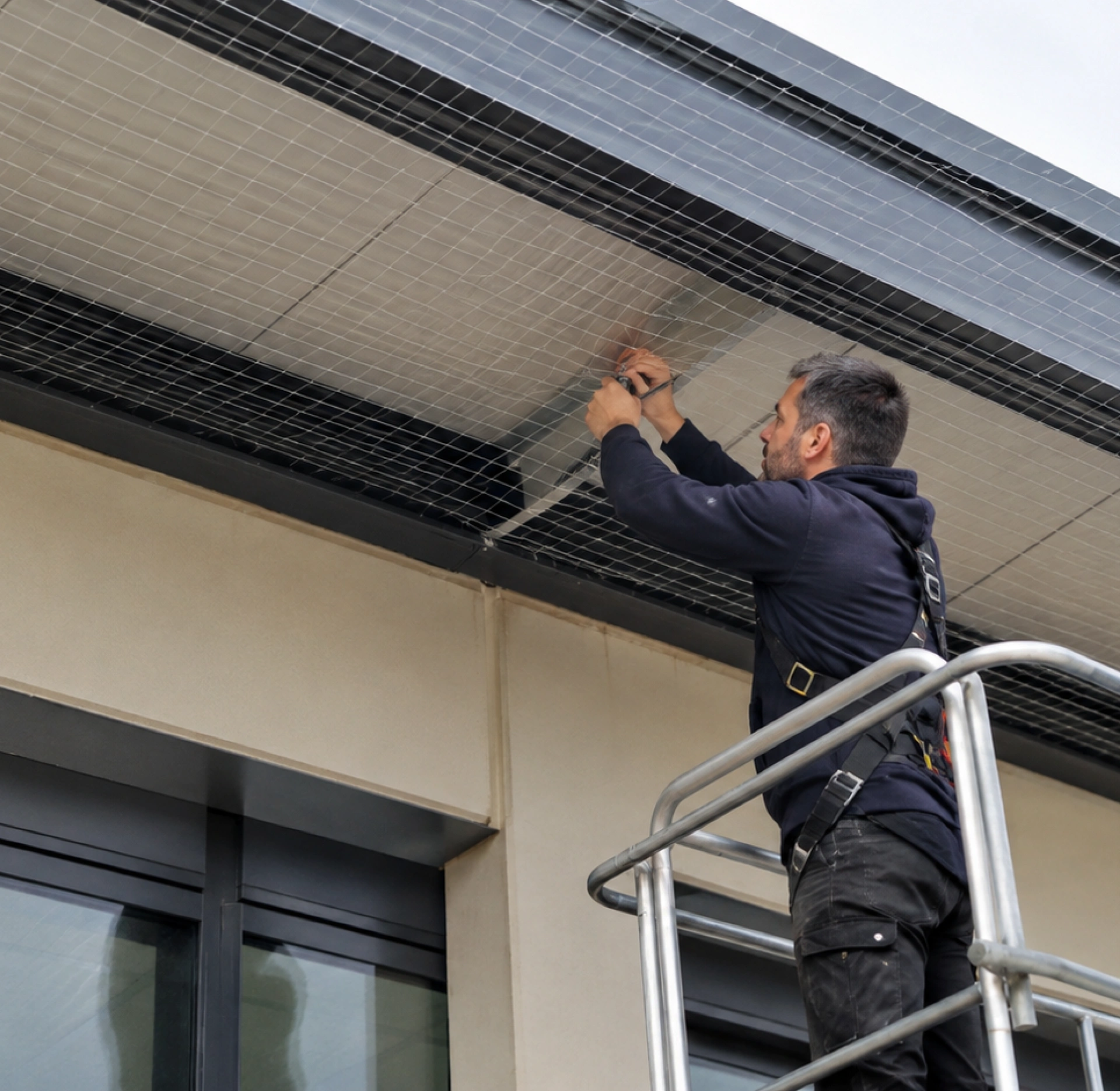 Allontanamento piccioni con rete anti-volatili installata sotto la gronda di un edificio